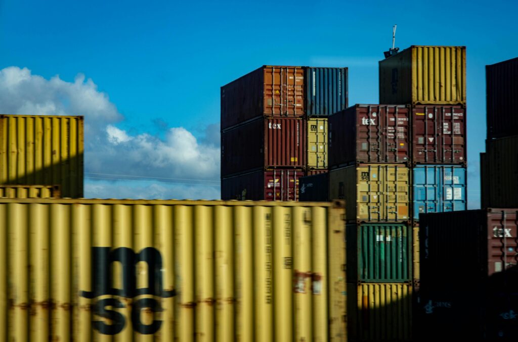 Stacked shipping containers at a port, the imports a release prior to payment bond secures for CBSA