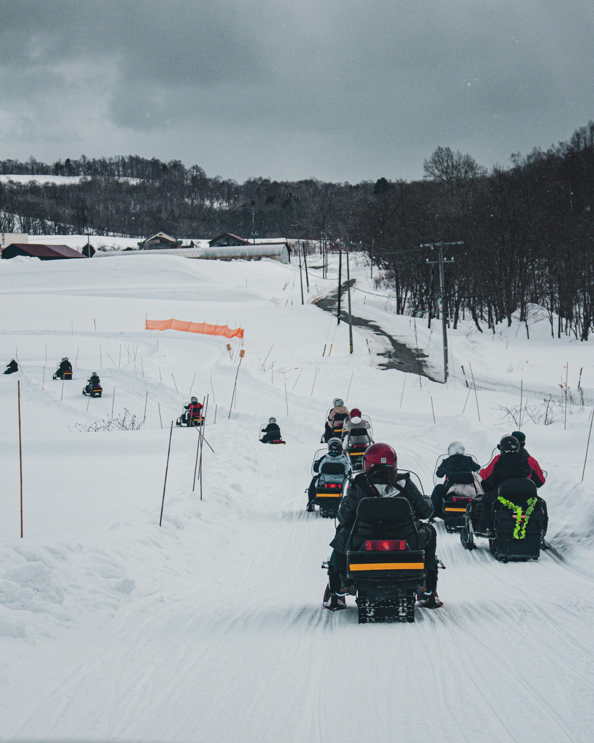 Riders on a groomed trail covered by snowmobile insurance