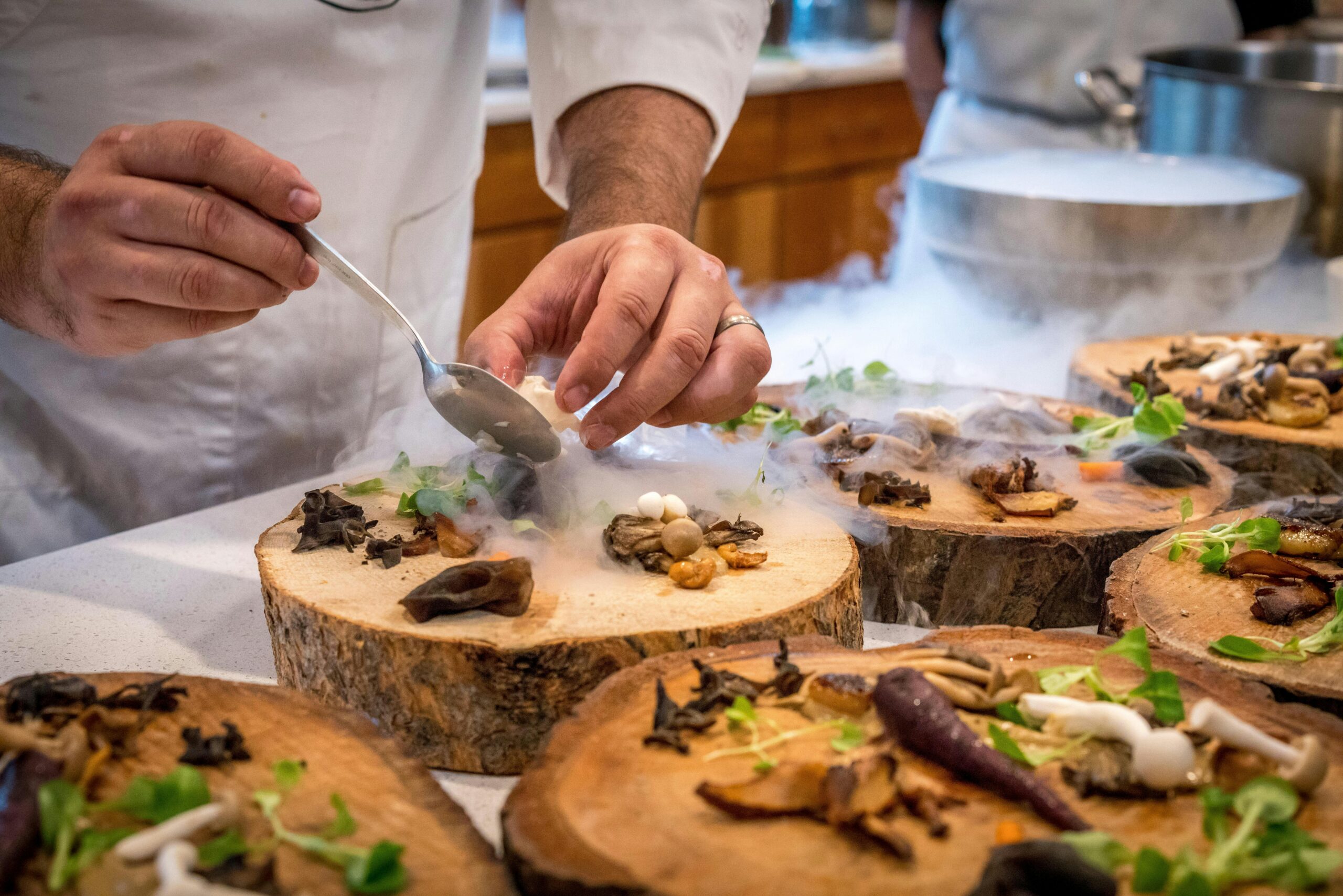 Chef plating food in a commercial kitchen — hospitality insurance and food safety in Nova Scotia