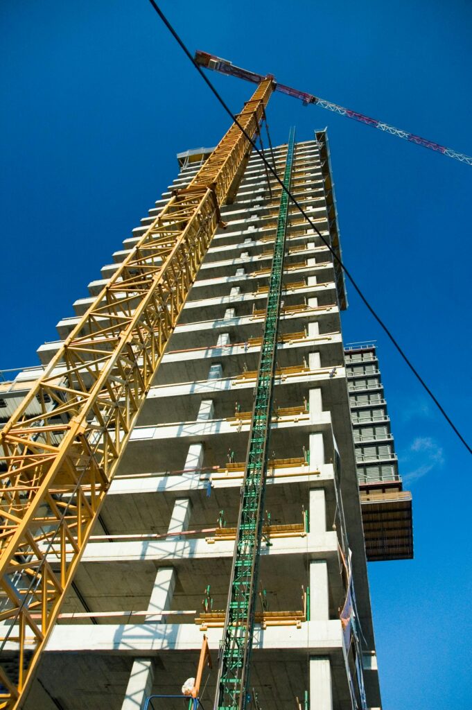 Tower crane over a building under construction — contractor insurance for commercial projects