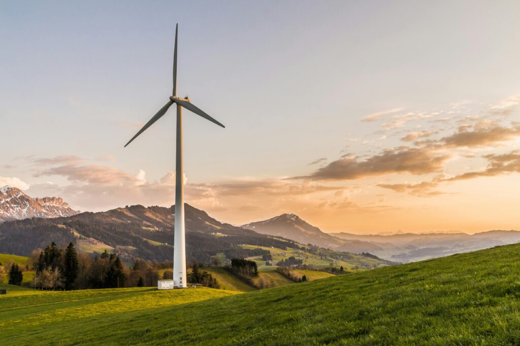 Wind turbine on rolling hills at sunset — renewable energy insurance for Nova Scotia projects