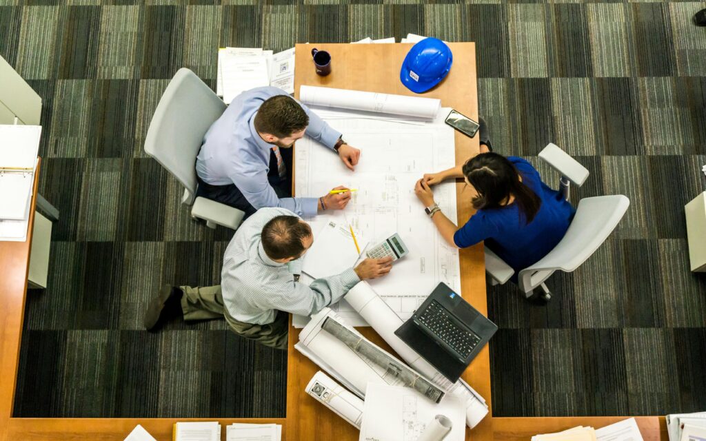 Construction team reviewing project drawings on site — contractor insurance for builders and developers