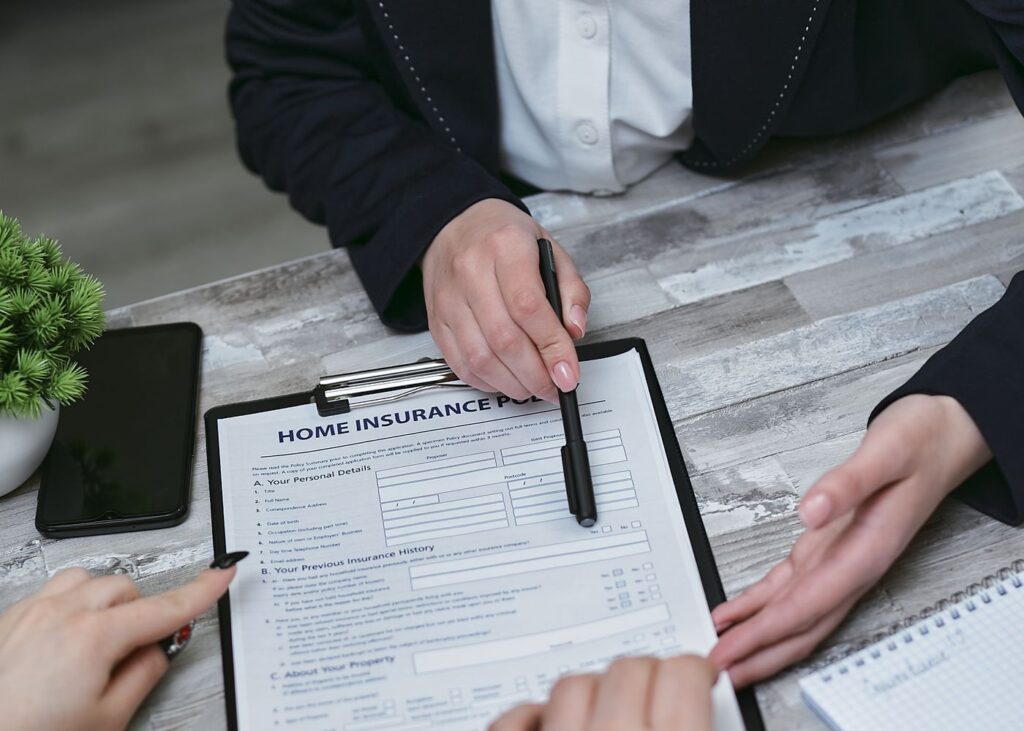 Insurance broker reviewing policy documents and appraisals with clients
