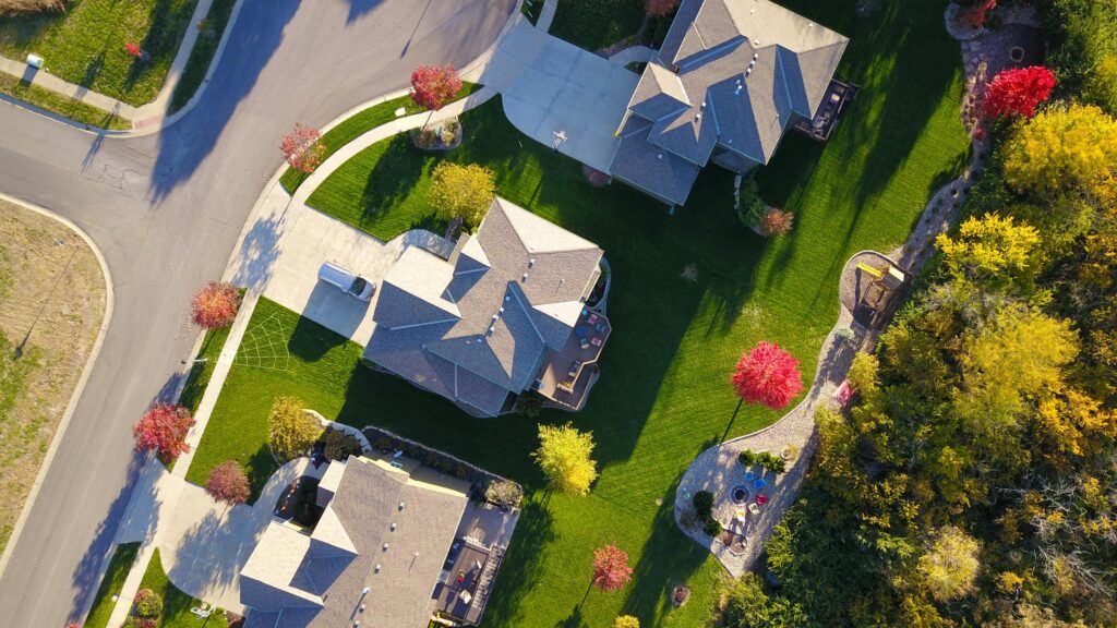 Aerial view of a completed residential subdivision with paved streets, curbs and sidewalks secured by a subdivision bond